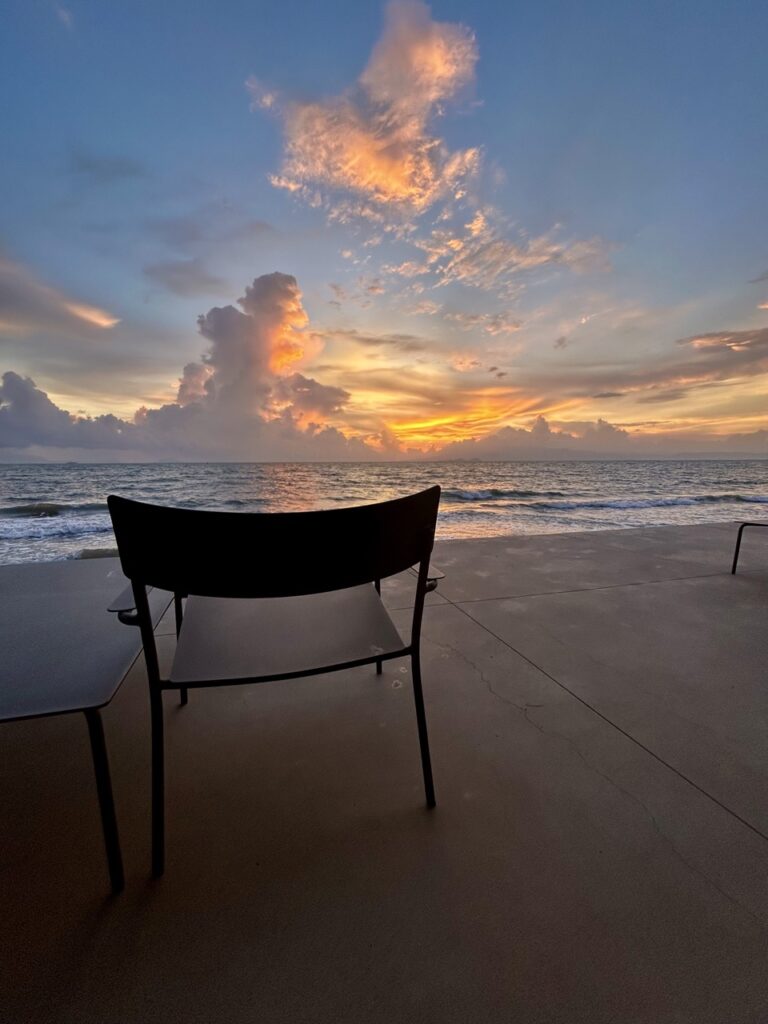 a chair, a table, the sea, sunset... in Kep